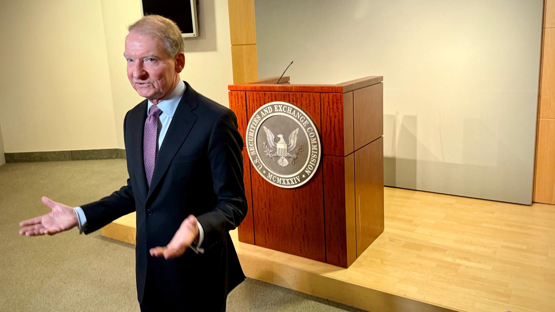 Person speaking in front of the SEC seal